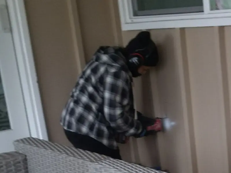 Professional electrician installing an exterior outlet in Brookshire
