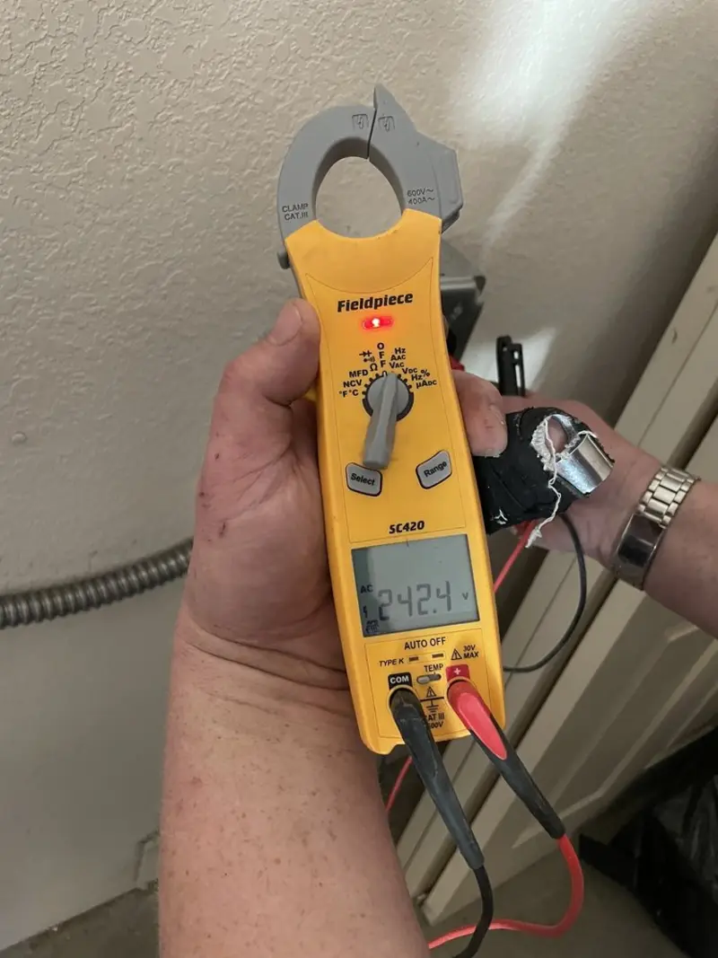 Voltage testing with clamp meter during Outlet Installation in Brookshire